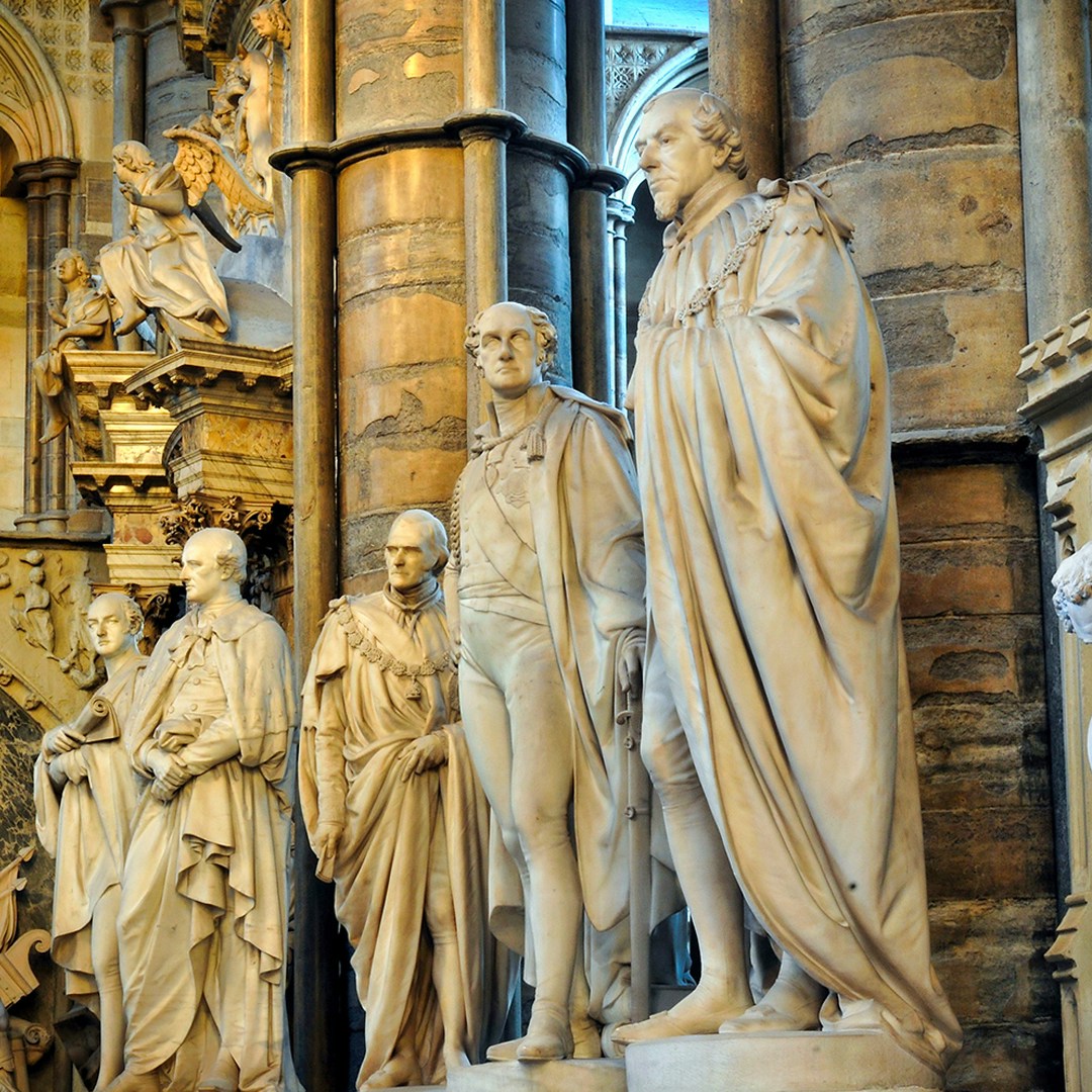 Statues of historical figures inside Westminster Abbey, London.