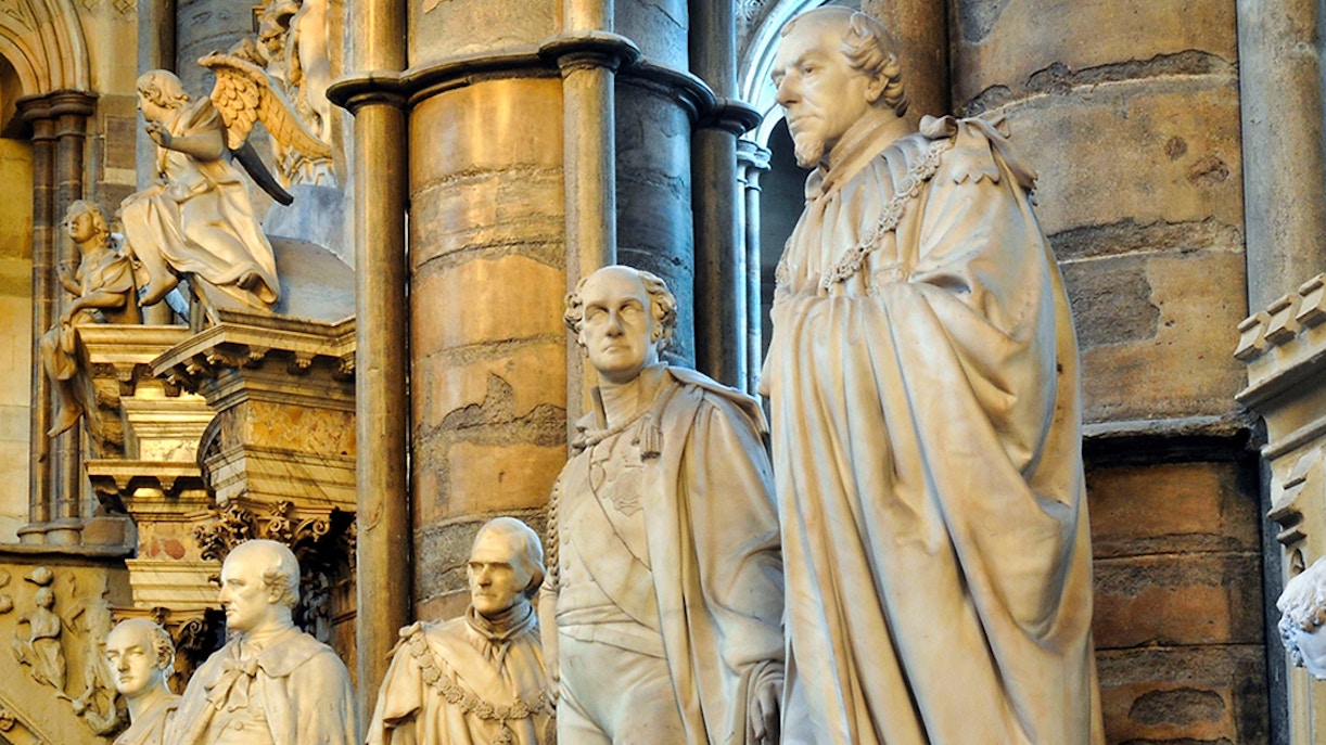 Statues of historical figures inside Westminster Abbey, London.