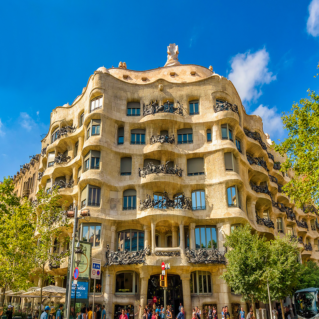 La Pedrera, Casa Mila facade in Barcelona with tourists outside.
