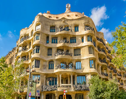 La Pedrera, Casa Mila facade in Barcelona with tourists outside.