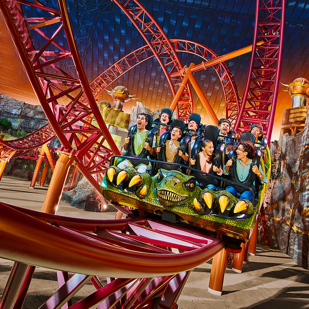 Visitors enjoying a thrilling roller coaster ride at IMG Worlds of Adventure, Dubai.