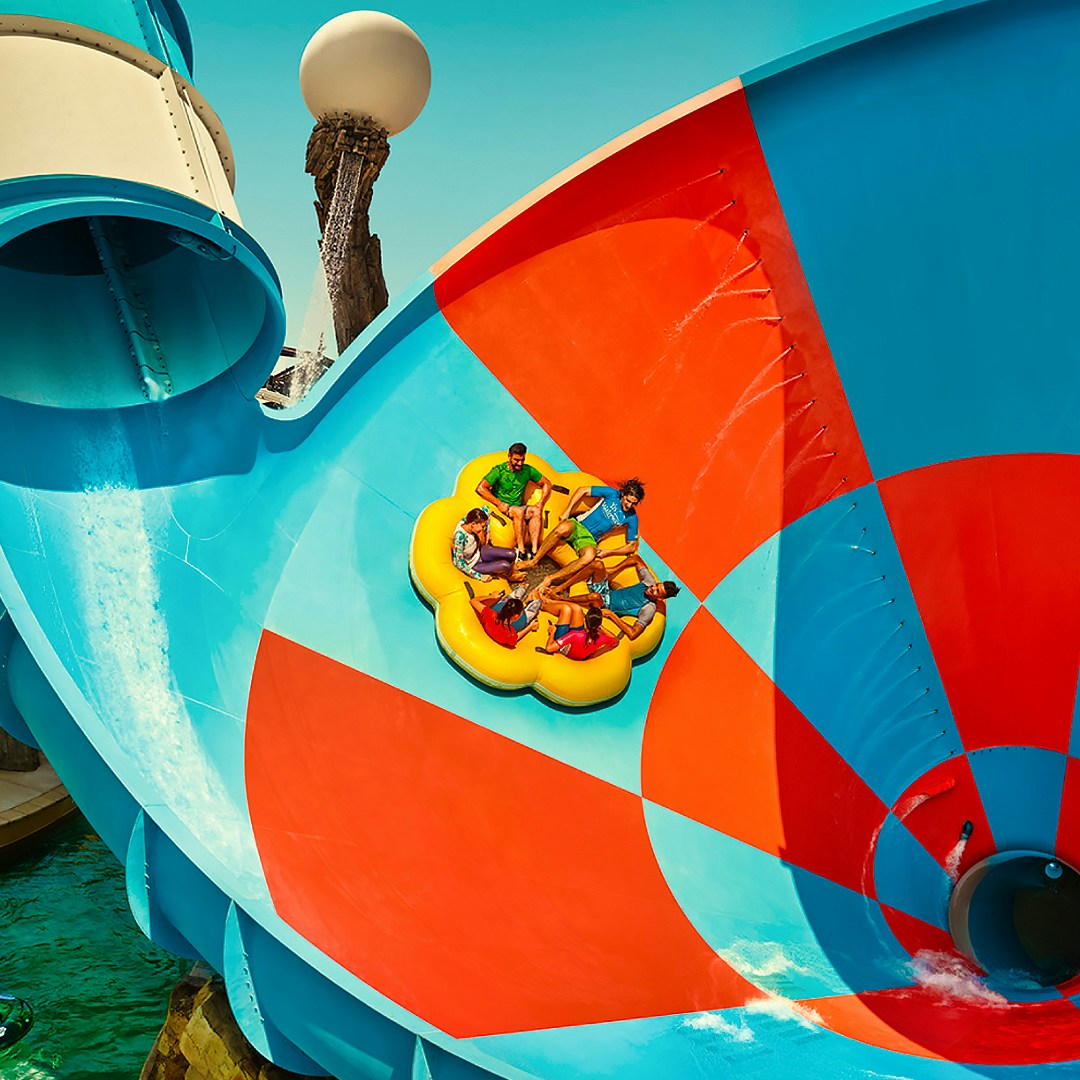 Group enjoying a water slide at Yas Waterworld, Abu Dhabi.