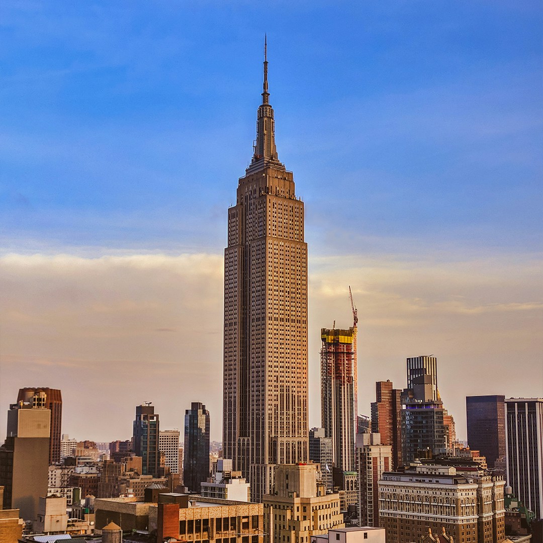 Empire State Building in New York City skyline at sunset.