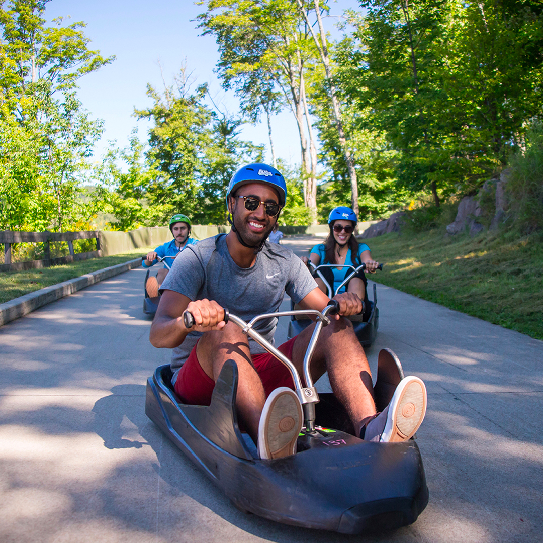 People enjoying a luge ride at Skyline Luge Singapore.