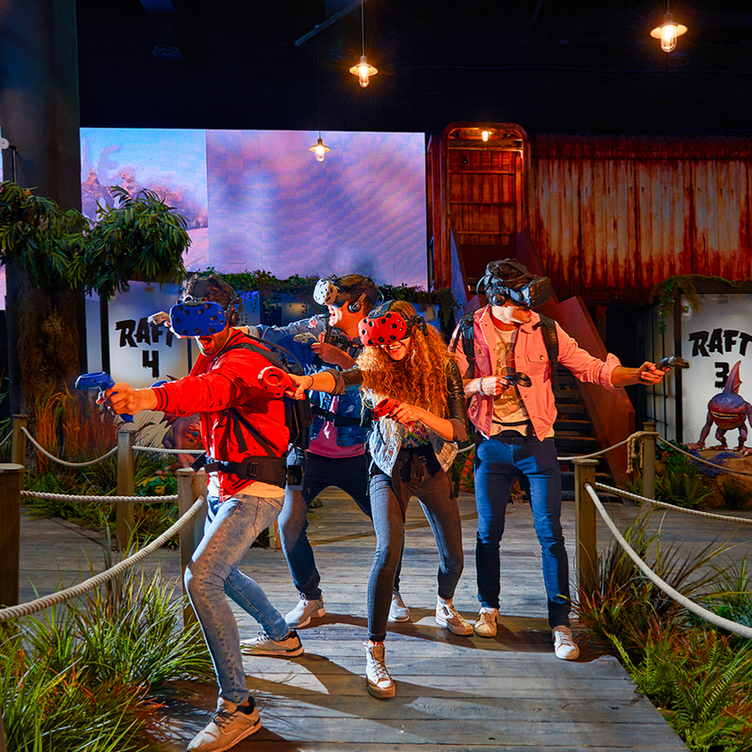 Visitors enjoying virtual reality games at Play DXB with VR headsets and controllers.