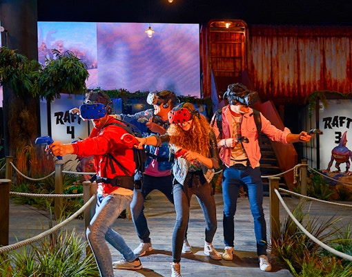 Visitors enjoying virtual reality games at Play DXB with VR headsets and controllers.