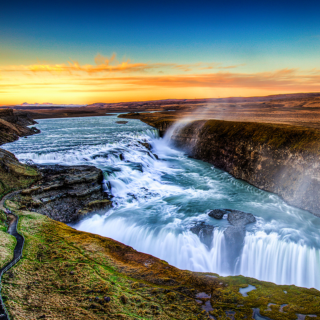 Gullfoss waterfall on the Golden Circle bus tour in Iceland at sunset.