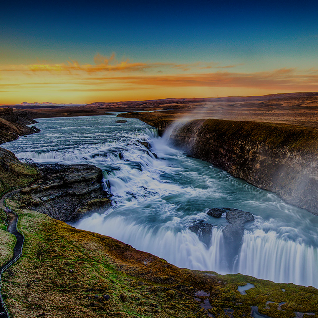 Gullfoss waterfall on the Golden Circle bus tour in Iceland at sunset.